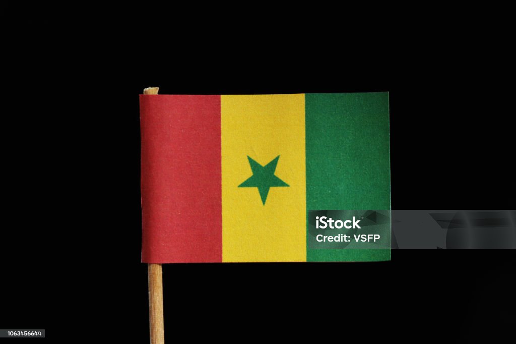 A official and original flag of Senegal on toothpick on black background. A vertical tricolour of green yellow and red with green star at the centre A official and original flag of Senegal on toothpick on black background. A vertical tricolour of green yellow and red with green star at the centre. Africa Stock Photo