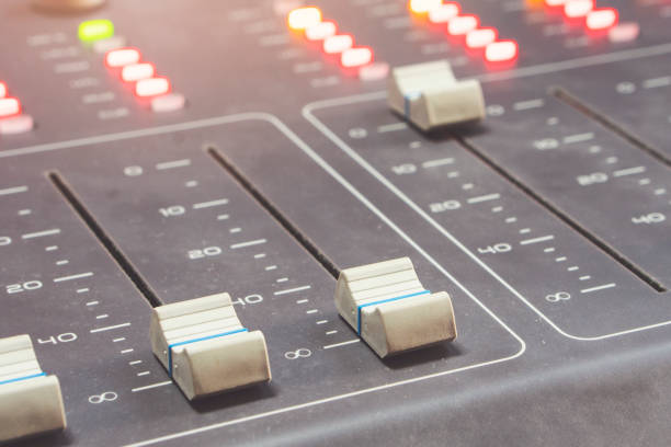 istock Professional audio mixing console with faders and adjusting knobs - radio / TV broadcasting 1063457086