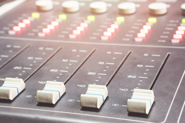 istock Professional audio mixing console with faders and adjusting knobs - radio / TV broadcasting 1063457090