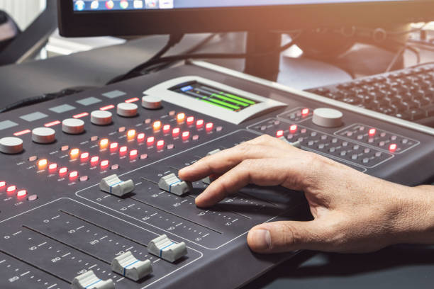 istock Professional audio mixing console with faders and adjusting knobs - radio / TV broadcasting 1063459692