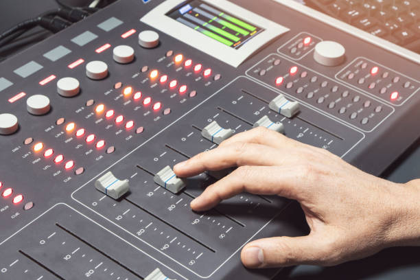 istock Professional audio mixing console with faders and adjusting knobs - radio / TV broadcasting 1063459696