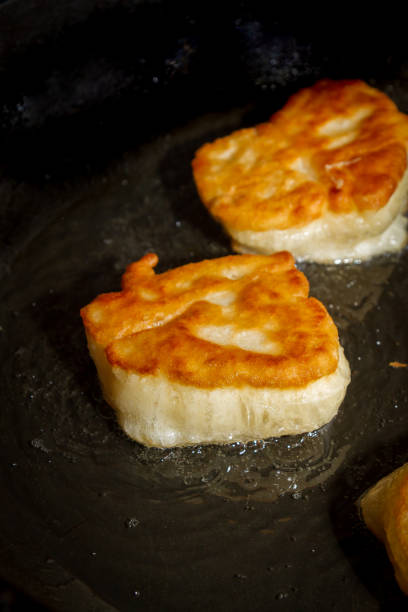 istock Cooking pancakes on a black pan with oil 1063459898