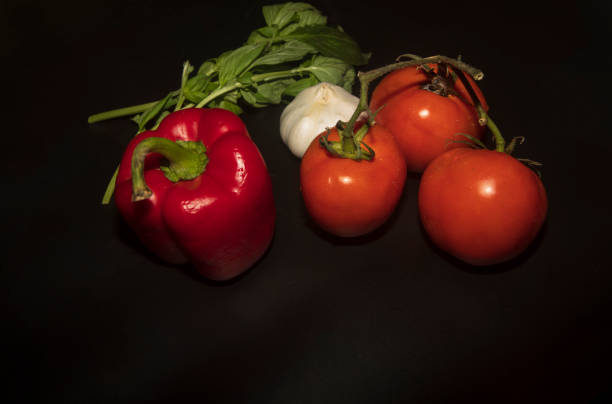 istock Group of vegetablesbasil  tomato, pepper and garlic on black background. 1063462042