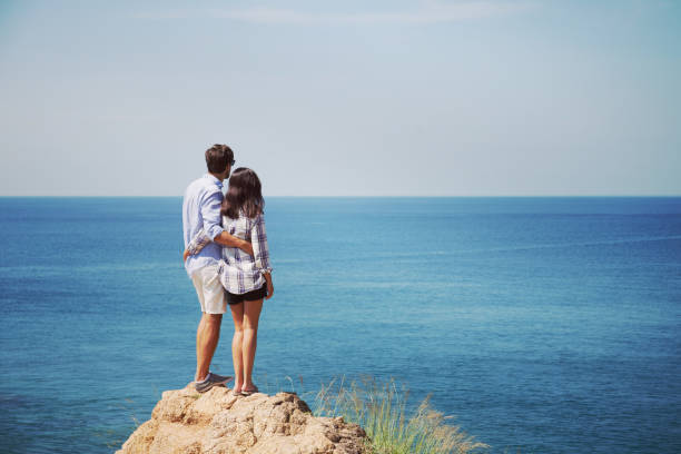 istock Young couple look at sea 1063462076