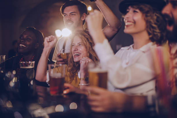 istock Friends in pub watching sports match 1063466516