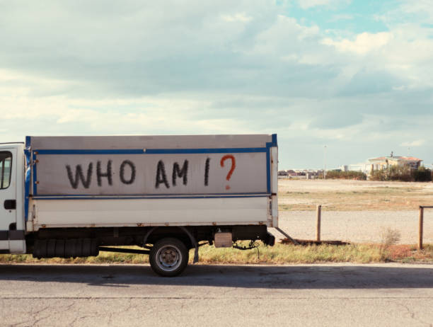 Who am I? Identity crisis "Ho am I?" is handwritten on the side of a parked truck. *** The text was digitally superimposed on the image and the release for it is provided *** motto stock pictures, royalty-free photos & images