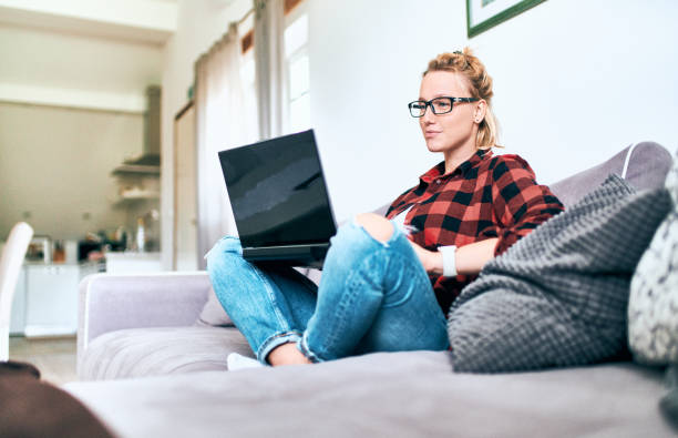 istock Pretty woman with laptop working at home 1063469752