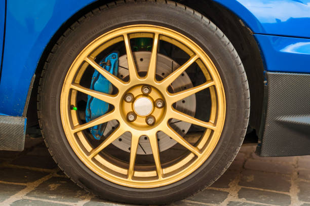 istock Golden rims on blue race car 1063471730