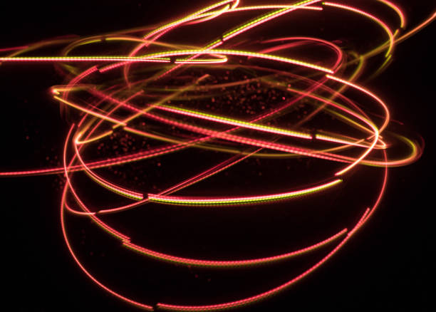 istock Overlaying wavy lines forming an abstract pattern on a dark background. Long exposure light background. 1063471912