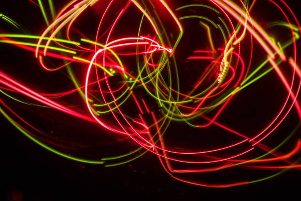 istock Overlaying wavy lines forming an abstract pattern on a dark background. Long exposure light background. 1063471924