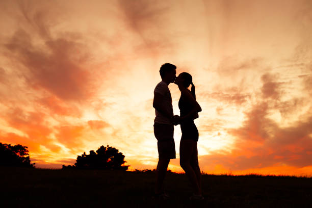 istock Couple kissing at sunset 1063475486