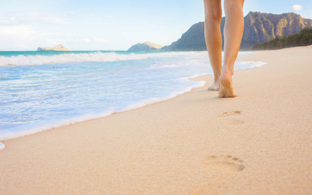istock Girl walking on the beach 1063475894