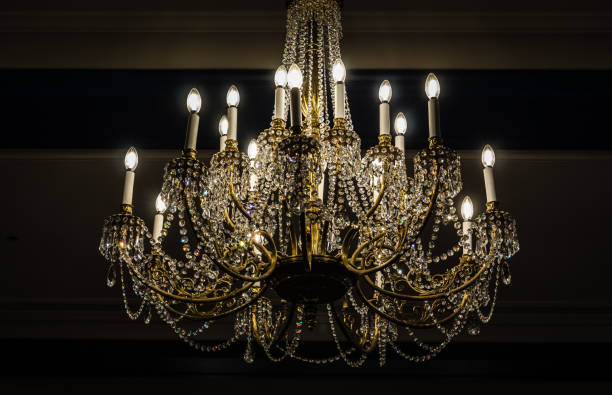 istock beautiful vintage style chandelier lit up hanging from ceiling. 1063482360