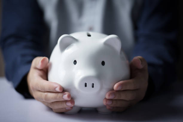 istock Hands Holding Piggy Bank 1063484580