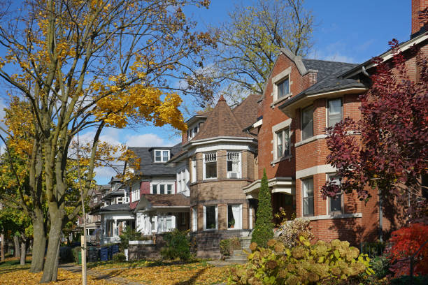 istock Tree lined residential street with fall colors 1063492556