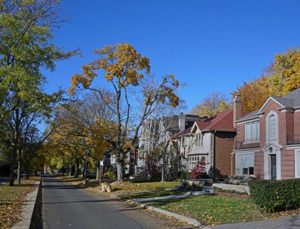 istock Tree lined residential street with fall colors 1063492558