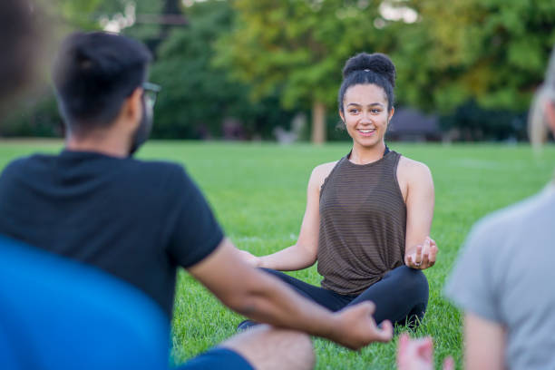 istock Leading an Outdoor Yoga Group 1063498078