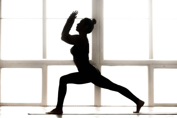 istock Young sporty attractive woman practicing yoga, doing Warrior one 1063498394