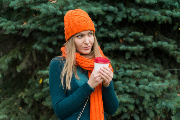 istock Young woman drinking tea outdoors in autumn 1063498670