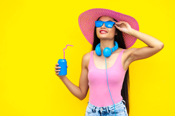 Smiling woman with pink hat holding blue can