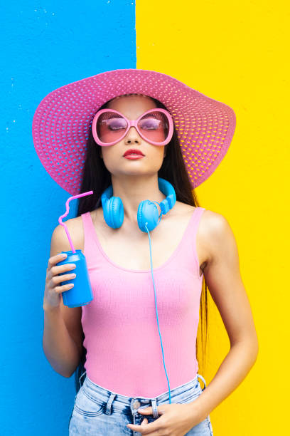 istock Woman with pink glasses holding blue can 1063498732