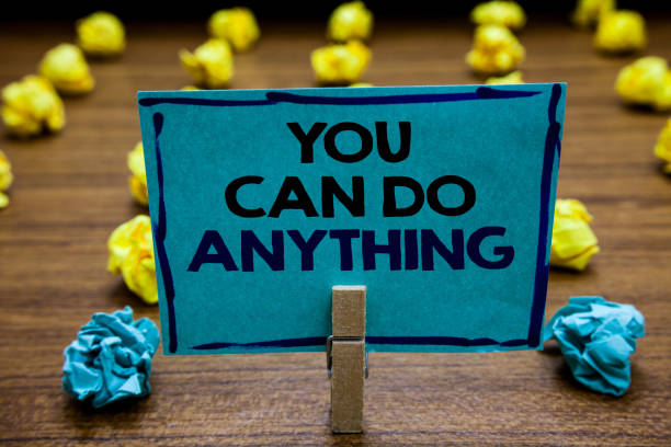 istock Handwriting text You Can Do Anything. Concept meaning Motivation for doing something Believe in yourself Blurry wooden deck yellow and blue lob on ground paper clip grip page with text. 1063499542
