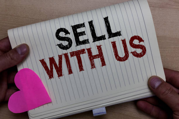 istock Word writing text Sell With Us. Business concept for Online selling platform looking for seller Electronic Commerce Man holding notebook paper heart Romantic ideas messages Wooden background. 1063500698