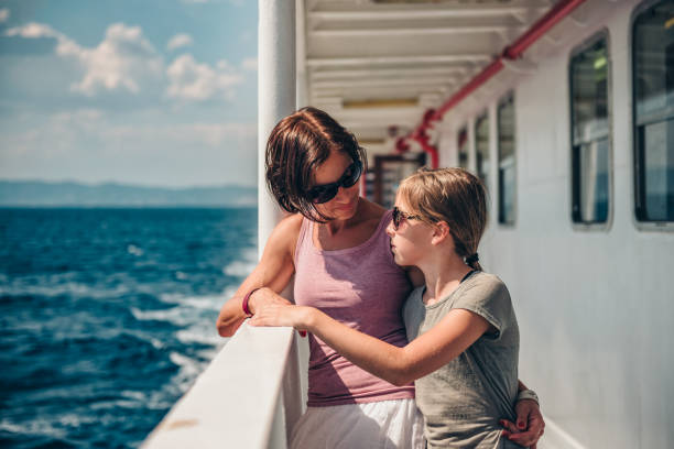 istock Mother and daughter standing on a ship deck and talking 1063512312