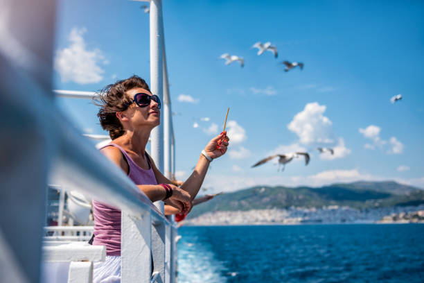 istock Woman feeding seagulls on the ferry boat 1063513004