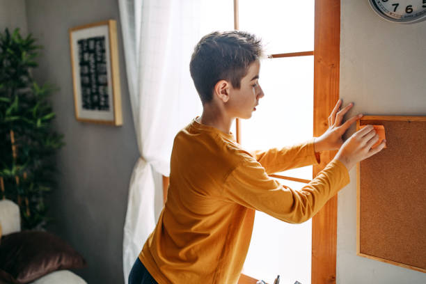 istock Teenage boy putting a sticker on the board 1063516092