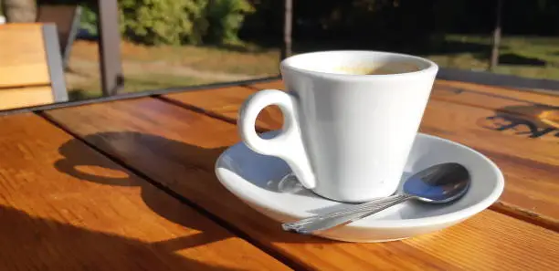 cup of coffee on wooden table