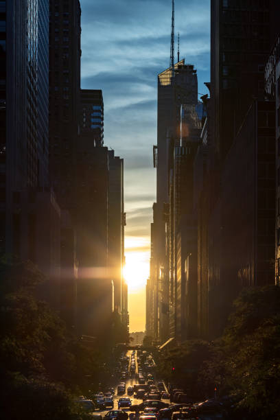 sunset between the buildings of midtown manhattan in new york city - new york canyon imagens e fotografias de stock