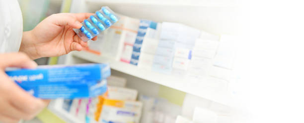 istock Pharmacist holding medicine box and capsule pack 1063532172