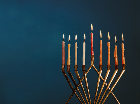 Menorah for Hanukkah celebration with candles for chanukah on black background