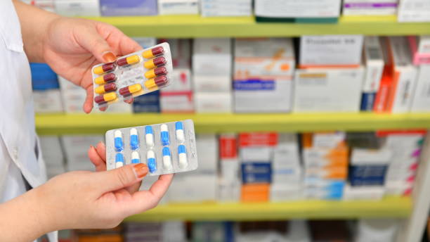 Pharmacist holding medicine capsule pack