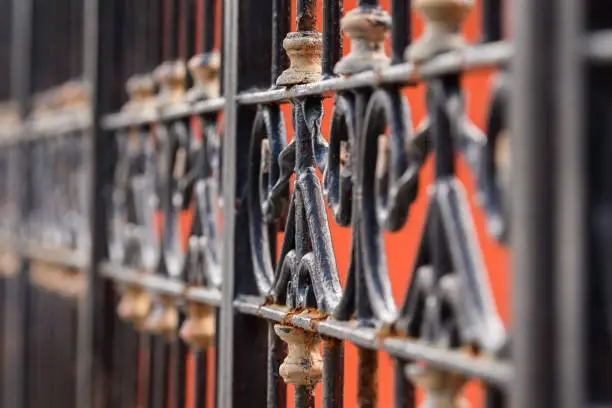 Photo of Decorative details of a rusty old colonial gate in Mexico