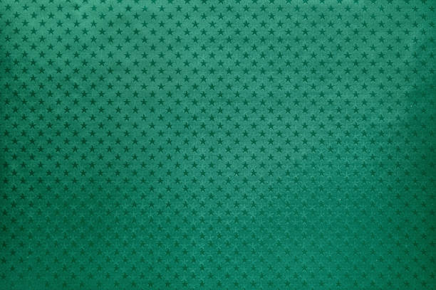 Green background from metal foil paper with a stars pattern