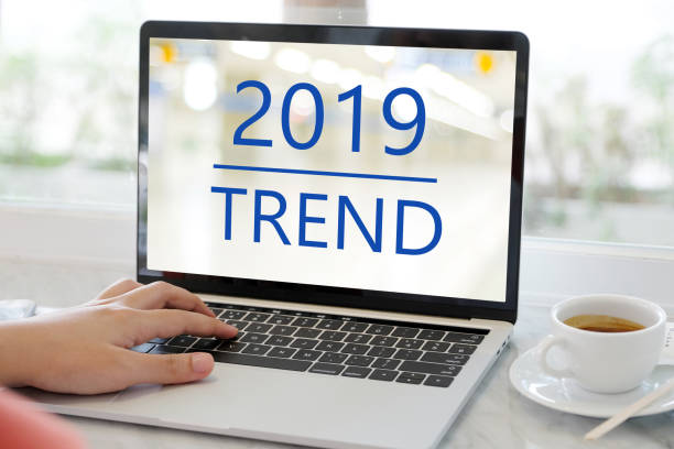 istock Man hand using laptop computer with 2019 trends on screen background, digital marketing, business and technology concept 1063555738