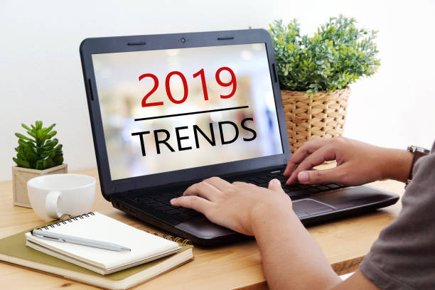 istock Man hand tying laptop computer with 2019 trends on screen background, digital marketing, business and technology concept 1063555794