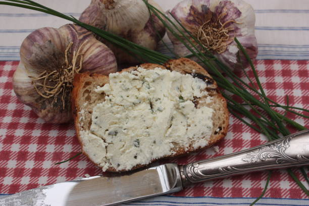 Fresh cheese with garlic and herbs on bread toast with dried figs \