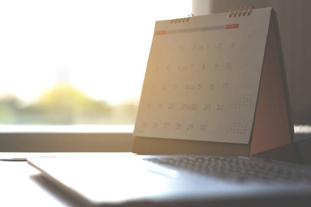 calendar on desk table and laptop keyboard city view background .