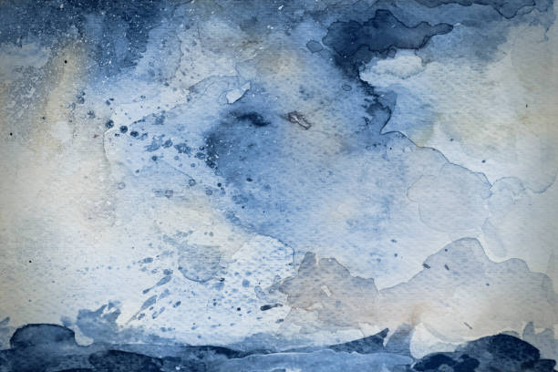 Blue watercolor background on watercolor paper with splashes