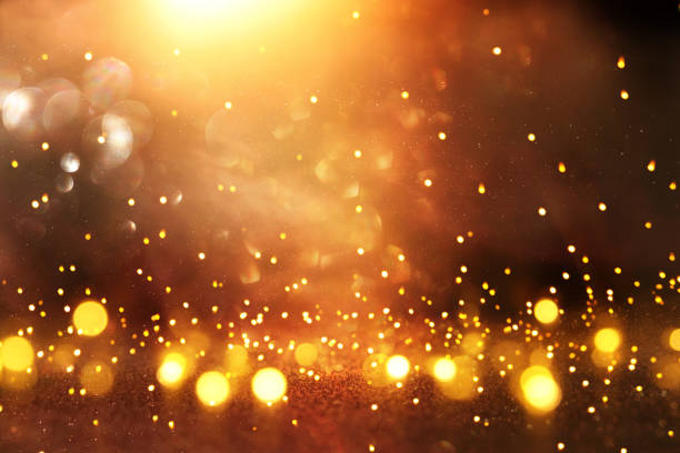 istock glitter vintage lights background. black and gold. de-focused. 1063572290