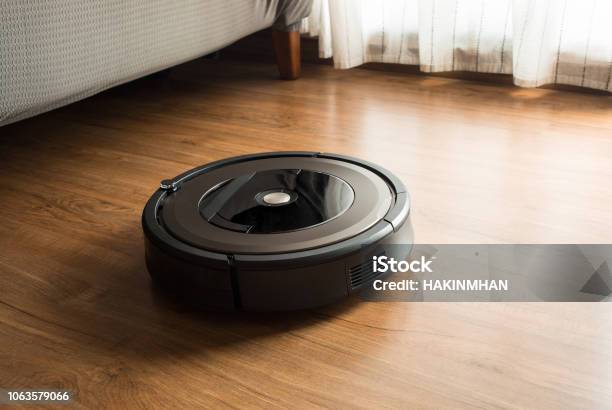 Robot Vacuum Cleaner On Woodlaminate Floorsmart Life Concepts Stock Photo - Download Image Now