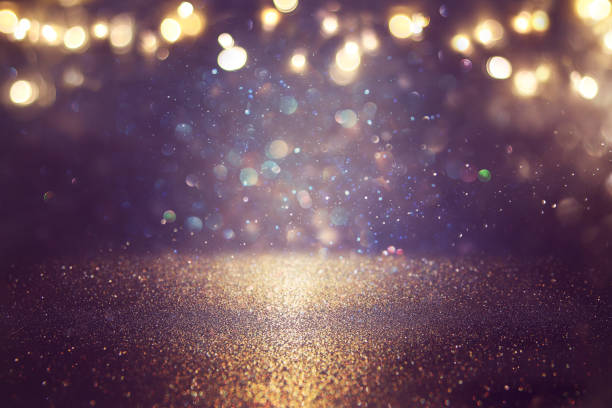 istock glitter vintage lights background. black and gold. de-focused. 1063583206