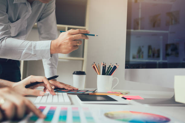 istock Designer holding pencil and pointing computer screen with working together. 1063595334