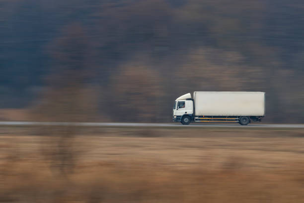 istock Truck going fast on a suburban road 1063607034