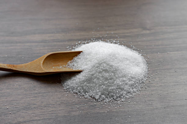 istock Sugar cube isolated on a wooden background. 1063610710