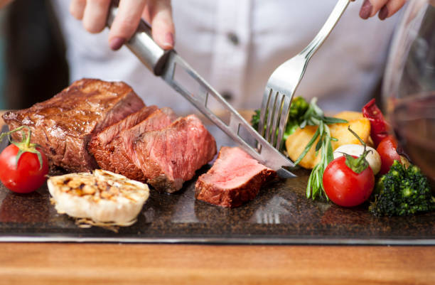 istock Woman eating steak 1063612550