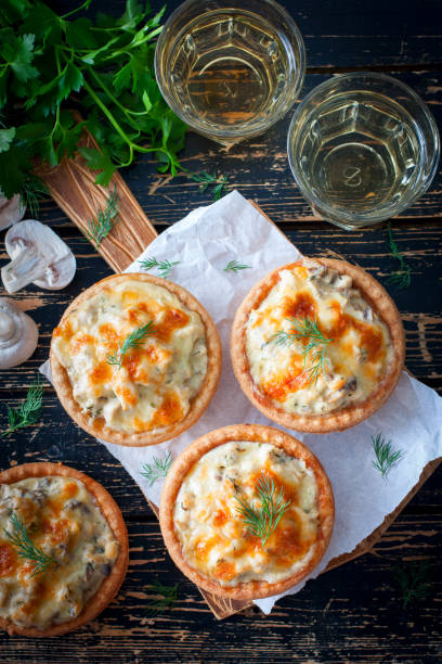 istock Tartlets with mushrooms, chicken and cheese, top view, selective focus 1063615650